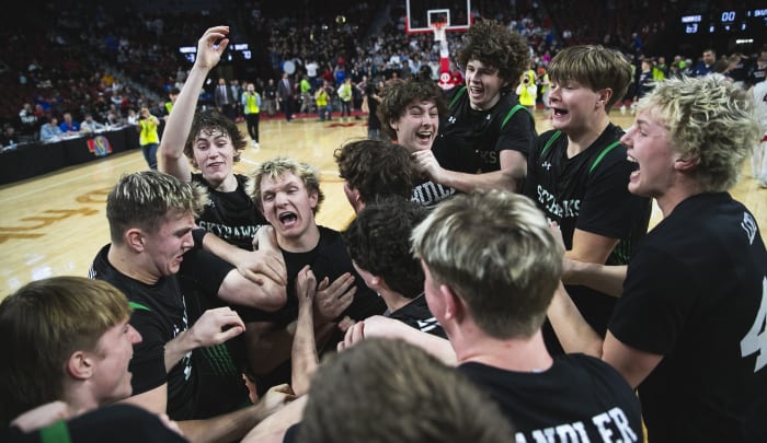 Skutt Catholic players celebrate together moments after winning the Class B boys basketball championship Saturday in Lincoln. It was the Skyhawks' second straight title and third in the past five years. Photo by @marcus_scheer on X.